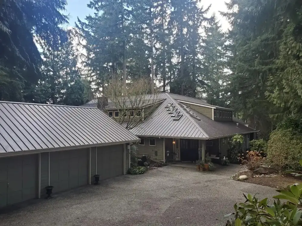 Standing seam metal roof on a Northwest home under evergreens